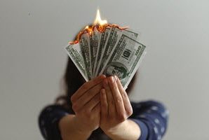 woman holding burnt cash